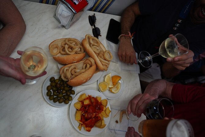 Madrid by Night: Tapas Crawl, Local Drinks & Hidden Gems - La Latina, small tables and local liquor