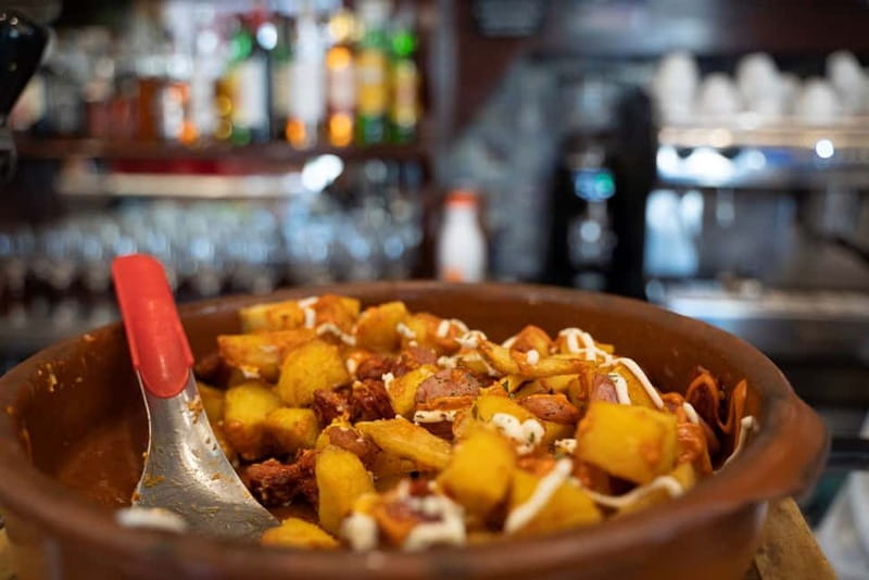 Madrid: Evening Tapas Tour with 5 Delicious Stops & Drinks - Plaza Mayor and the famous calamari sandwich
