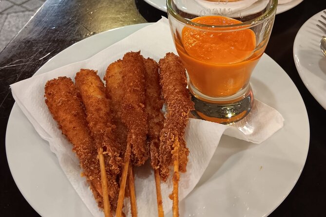 Madrid Food Tour: Tapas, Drinks and Delights with a Local - Plaza de Jacinto Benavente and tortilla de patatas